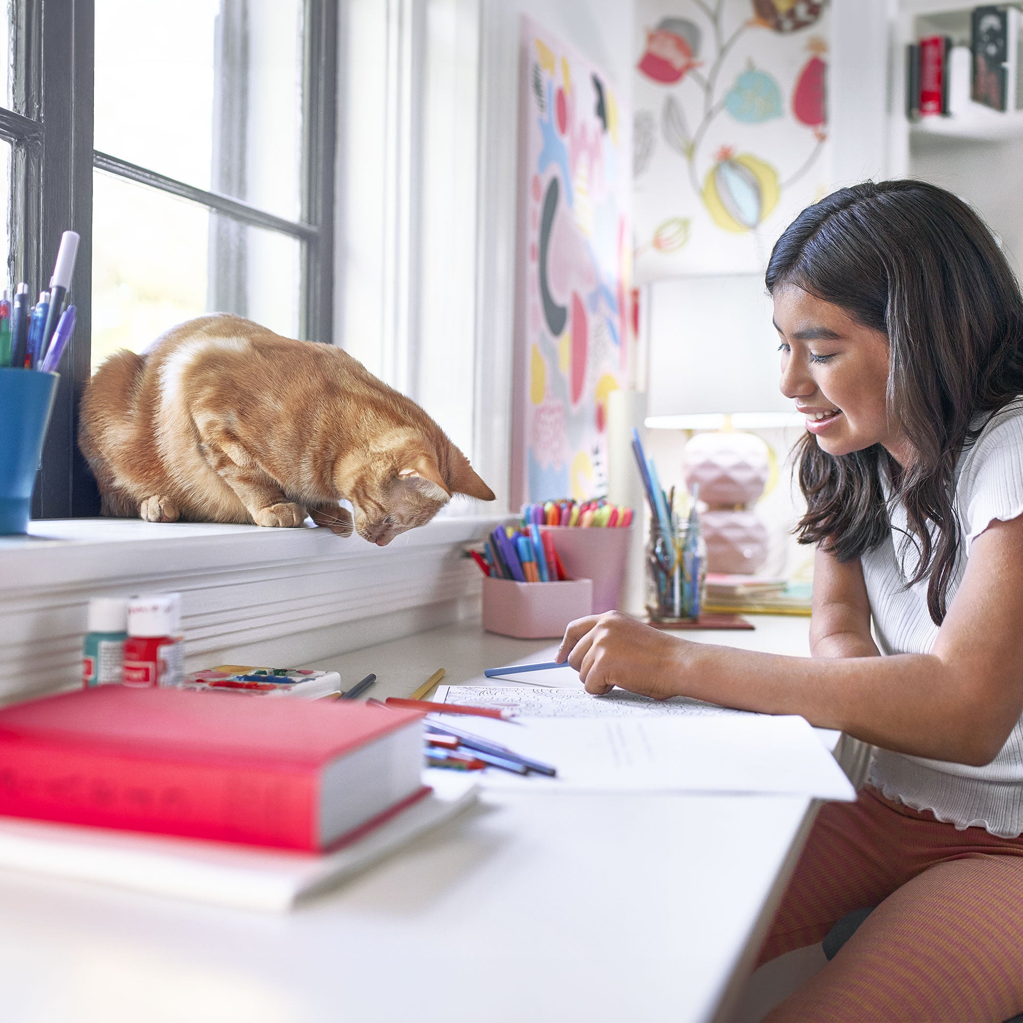 A girl playing with a cat