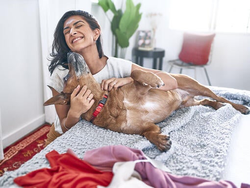 Woman cuddling dog